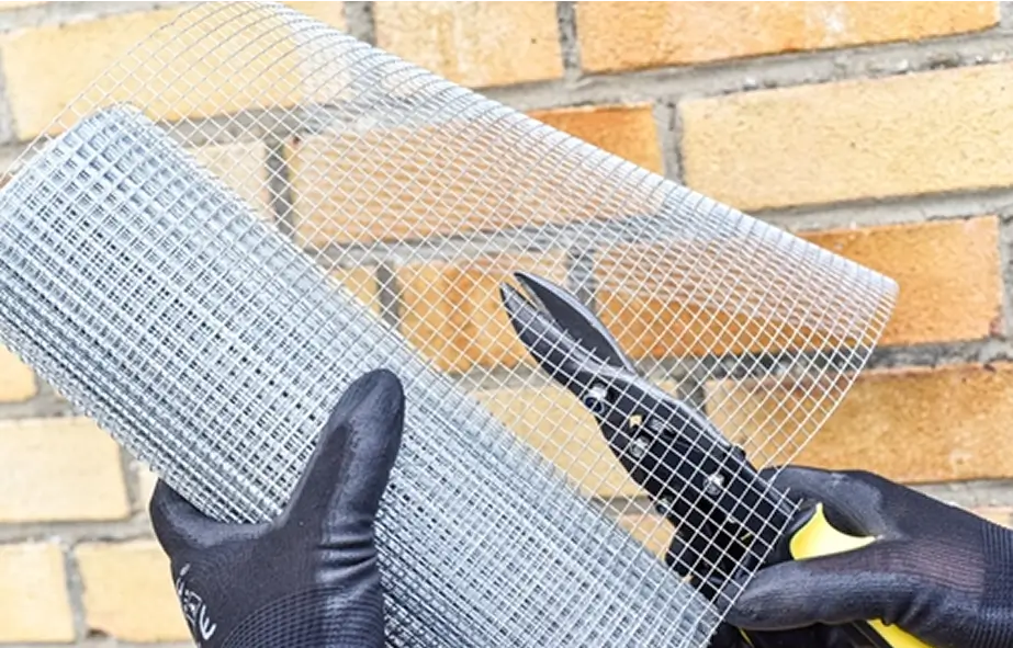 Hardware cloth being cut and installed for rodent exclusion in a Hayes Valley home